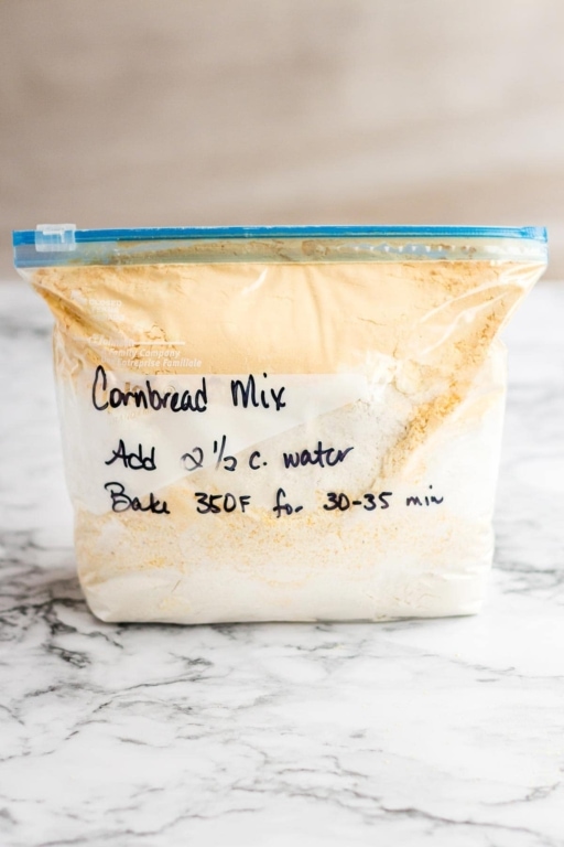 Quart ziptop bag containing homemade cornbread mix, with instructions written on the outside with Sharpie pen.