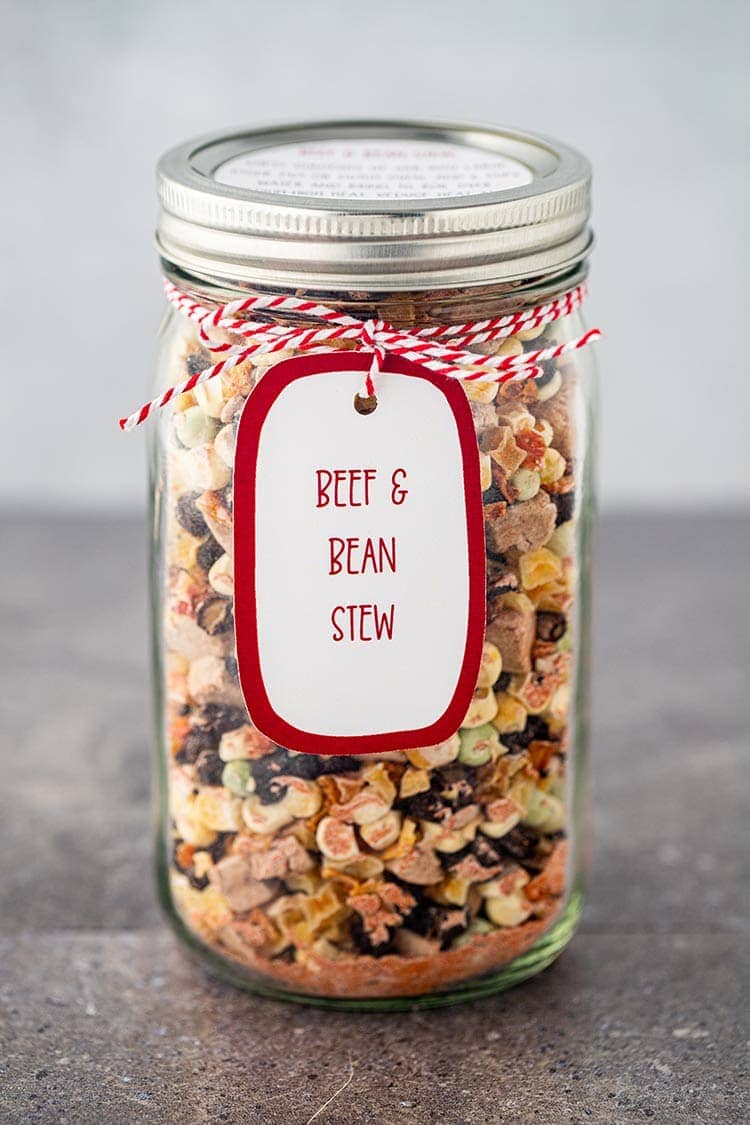Ingredients for Beef and Bean Stew in a Jar, in a wide-mouth mason jar, with label and gift tag.