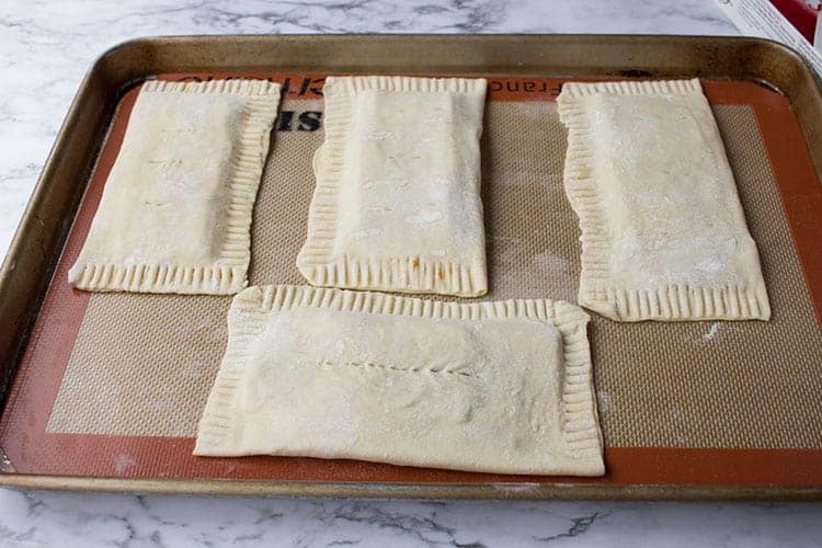 Puff pastry on silicone mat for homemade hot pockets.