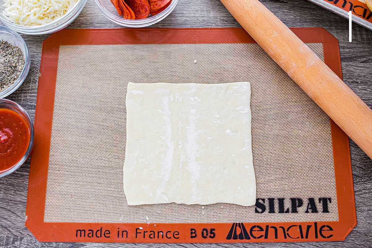 Overhead shot of puff pastry on a silicone mat.