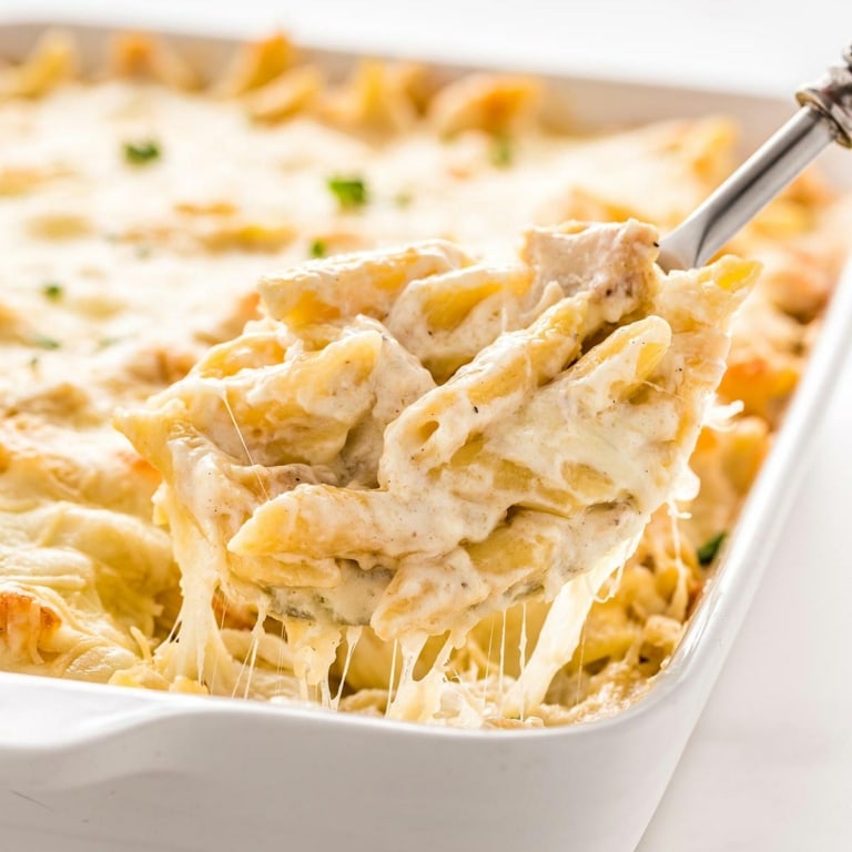 Close up of Chicken Alfredo Bake being dished for serving.