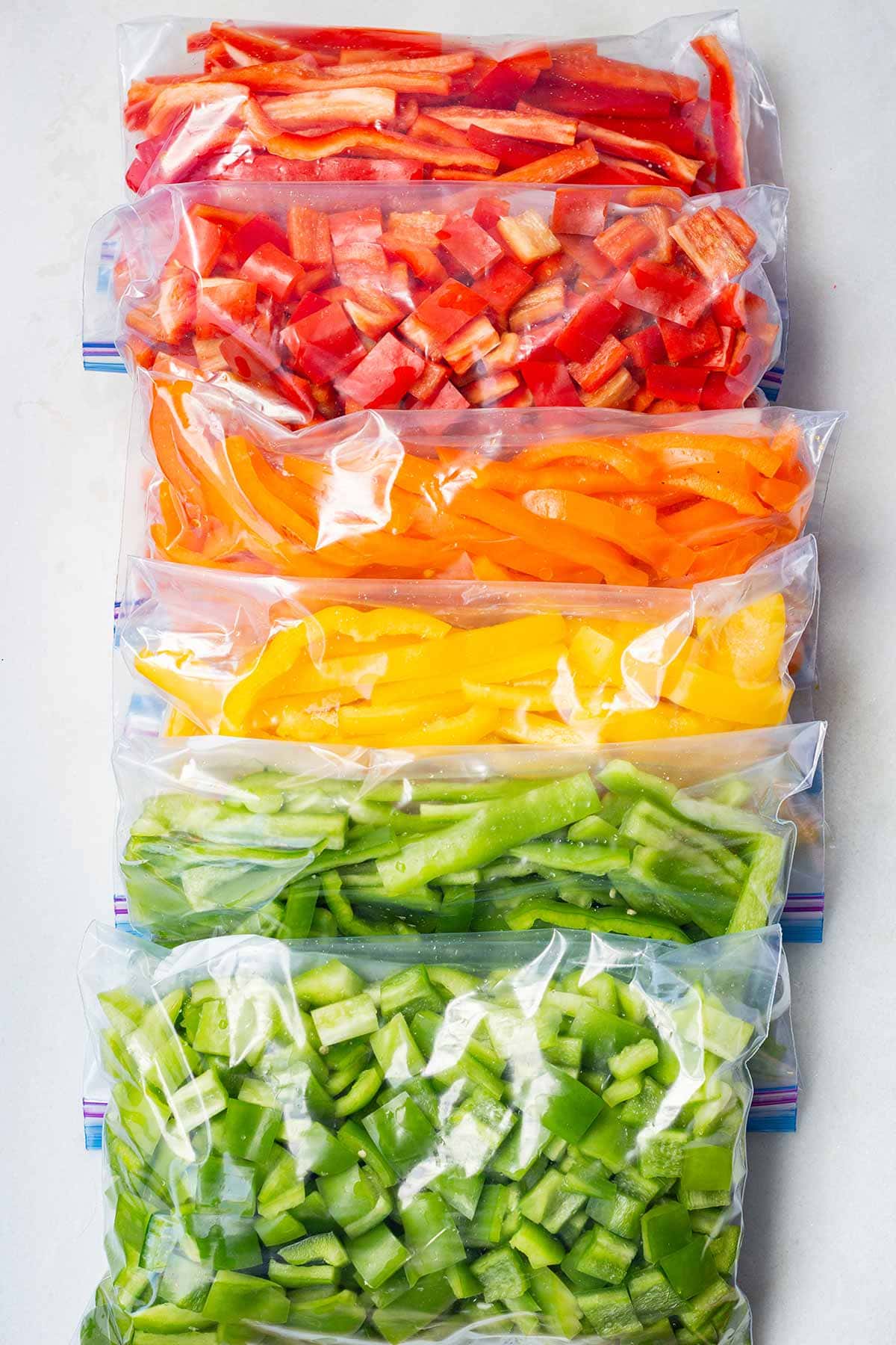 Bags of sliced and diced bell peppers ready for freezing.