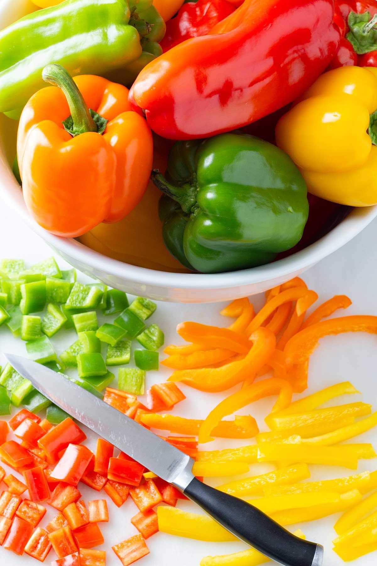 Whole bell peppers ready to be sliced and diced for freezing.