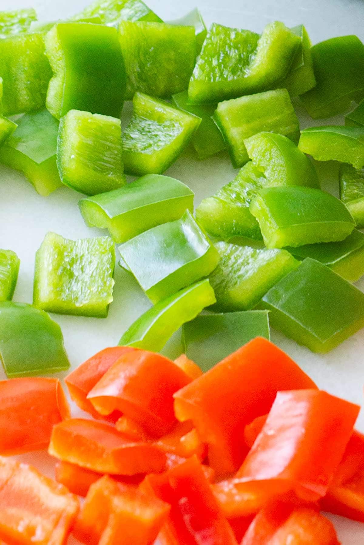 Closeup of diced red and green bell peppers for freezing.