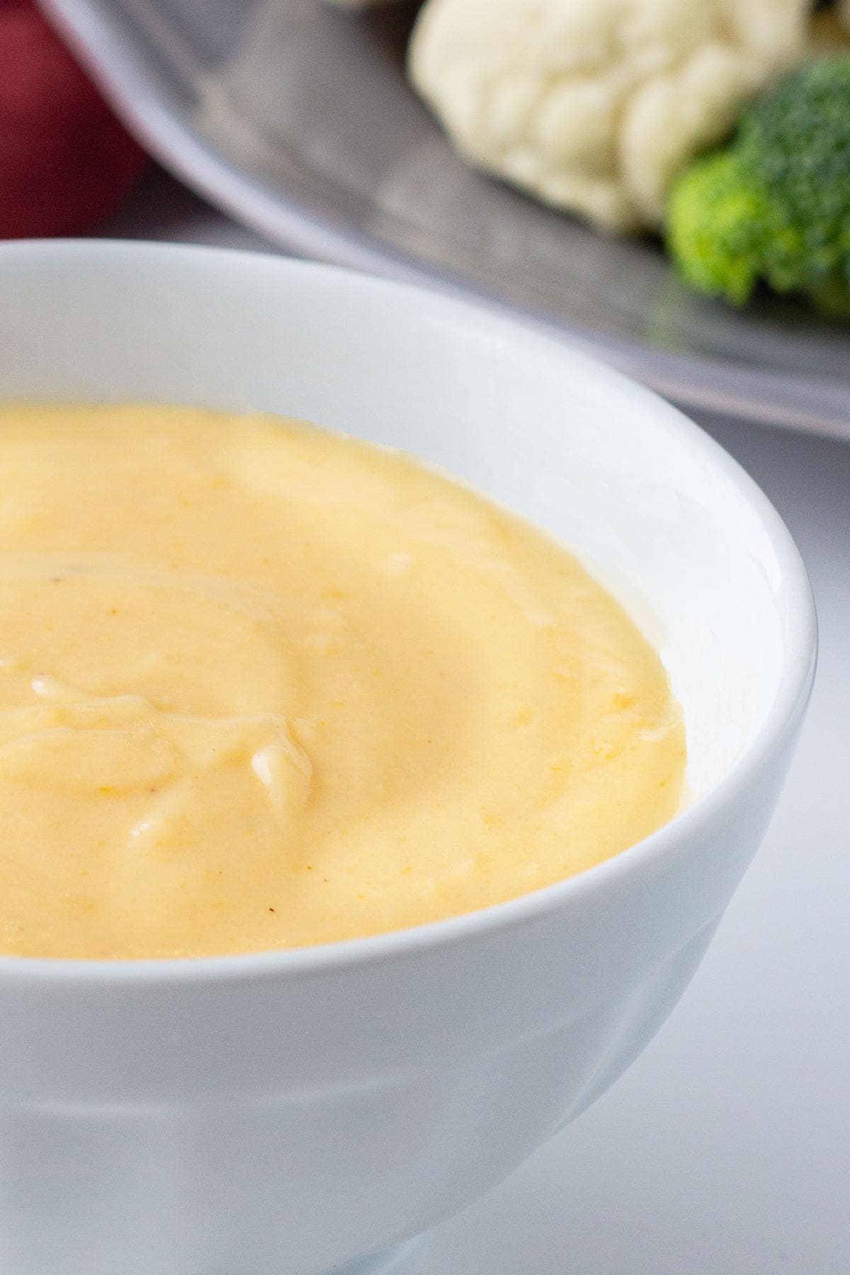 Closeup of prepared Freezer Cheese Sauce in a white bowl.