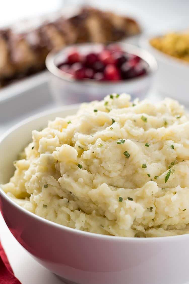 Garlic Herb Mashed Potatoes with cranberries in background