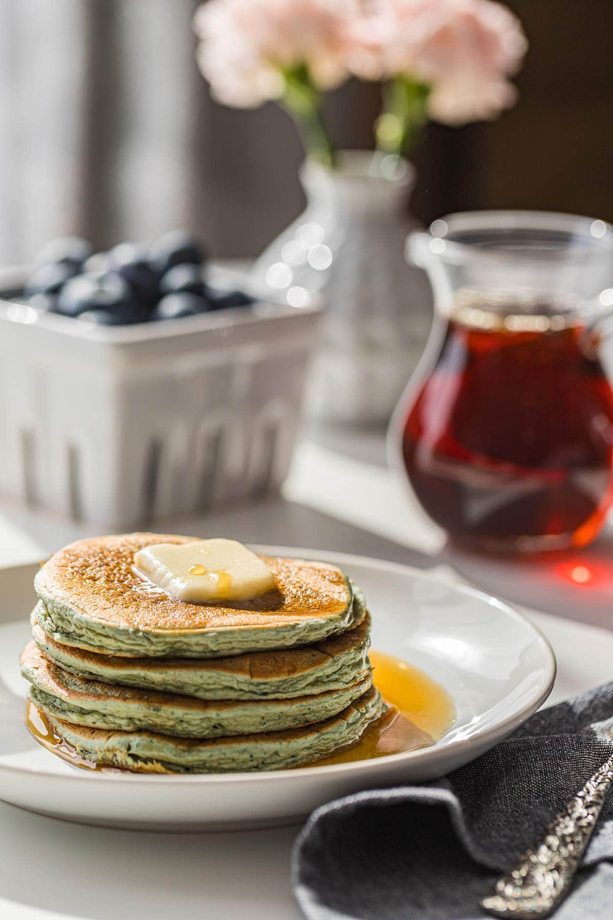 Backlit plate of Leftover Oatmeal Blender Pancakes on breakfast table.