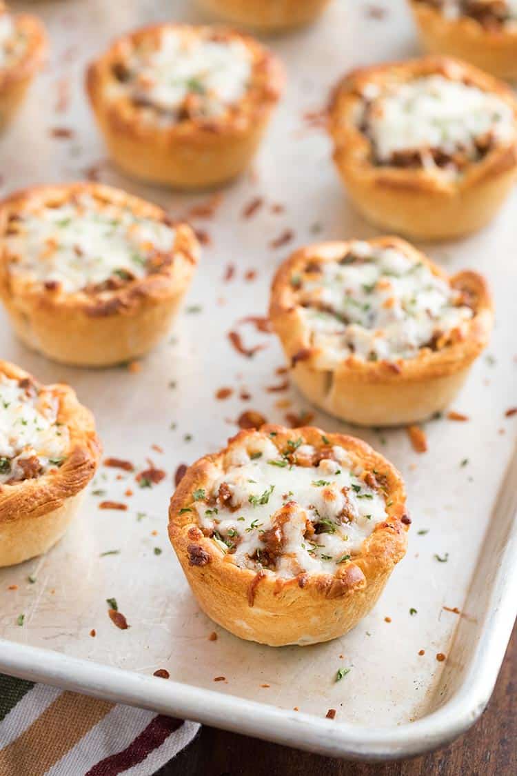 Savory Italian Biscuit Cups after final bake, on baking sheet with melted cheese on top