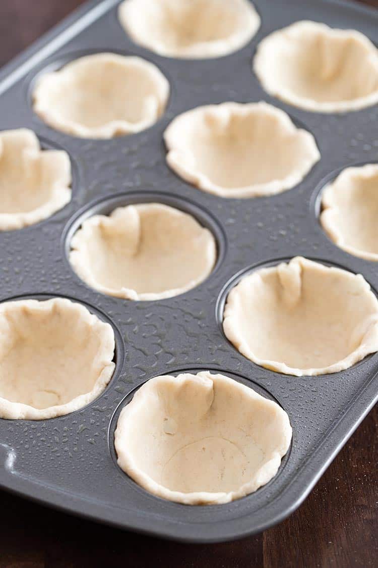 Savory Italian Biscuit Cups, process shot showing biscuit dough pressed into muffin tin