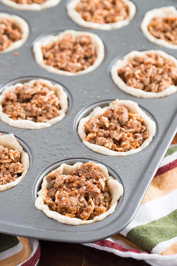 Savory Italian Biscuit Cups, prepared in muffin tin and ready to bake