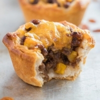 Barbecue Beef Biscuit Cup on baking tray with bite taken out of it.