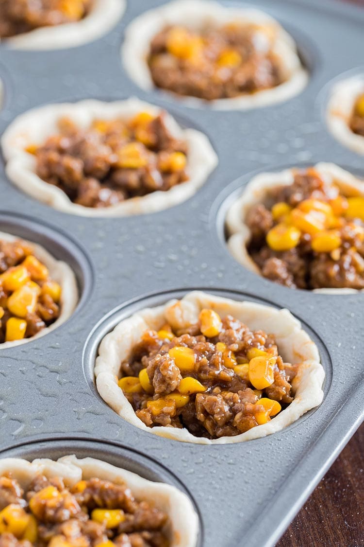 Beefy Barbecue Biscuit Cups prepared in muffin tin before baking