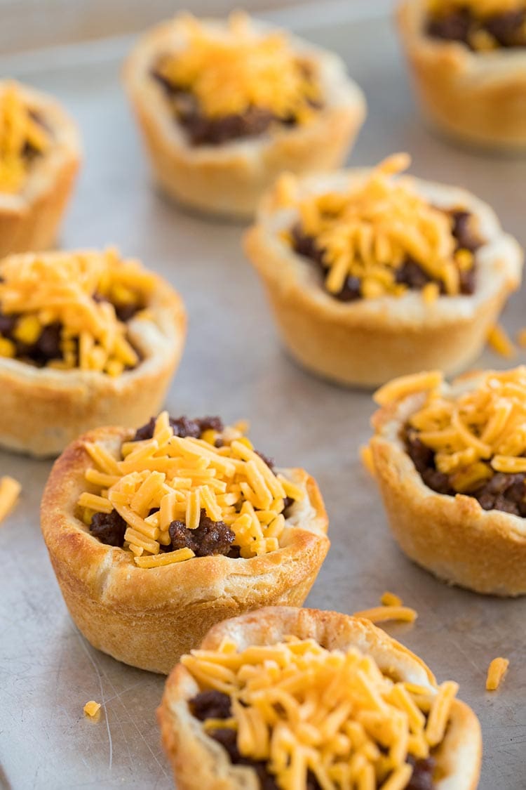 Beefy Barbecue Biscuit Cups ready to be reheated on sheet tray