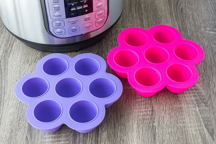 Picture of silicone molds used for making Bacon Cheddar Egg Bites in an Instant Pot, each mold is in the shape of a large flower with 7 cups where food can go