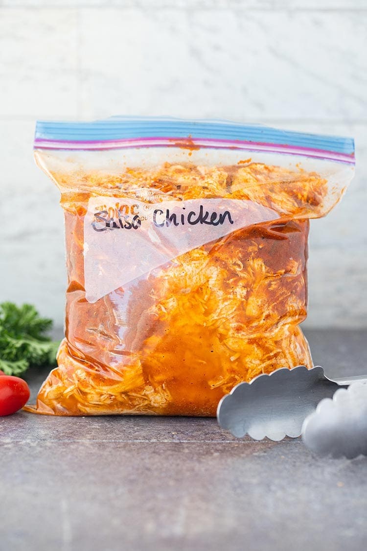 Instant Pot Salsa Chicken shredded and packaged in ziptop bag for freezer.