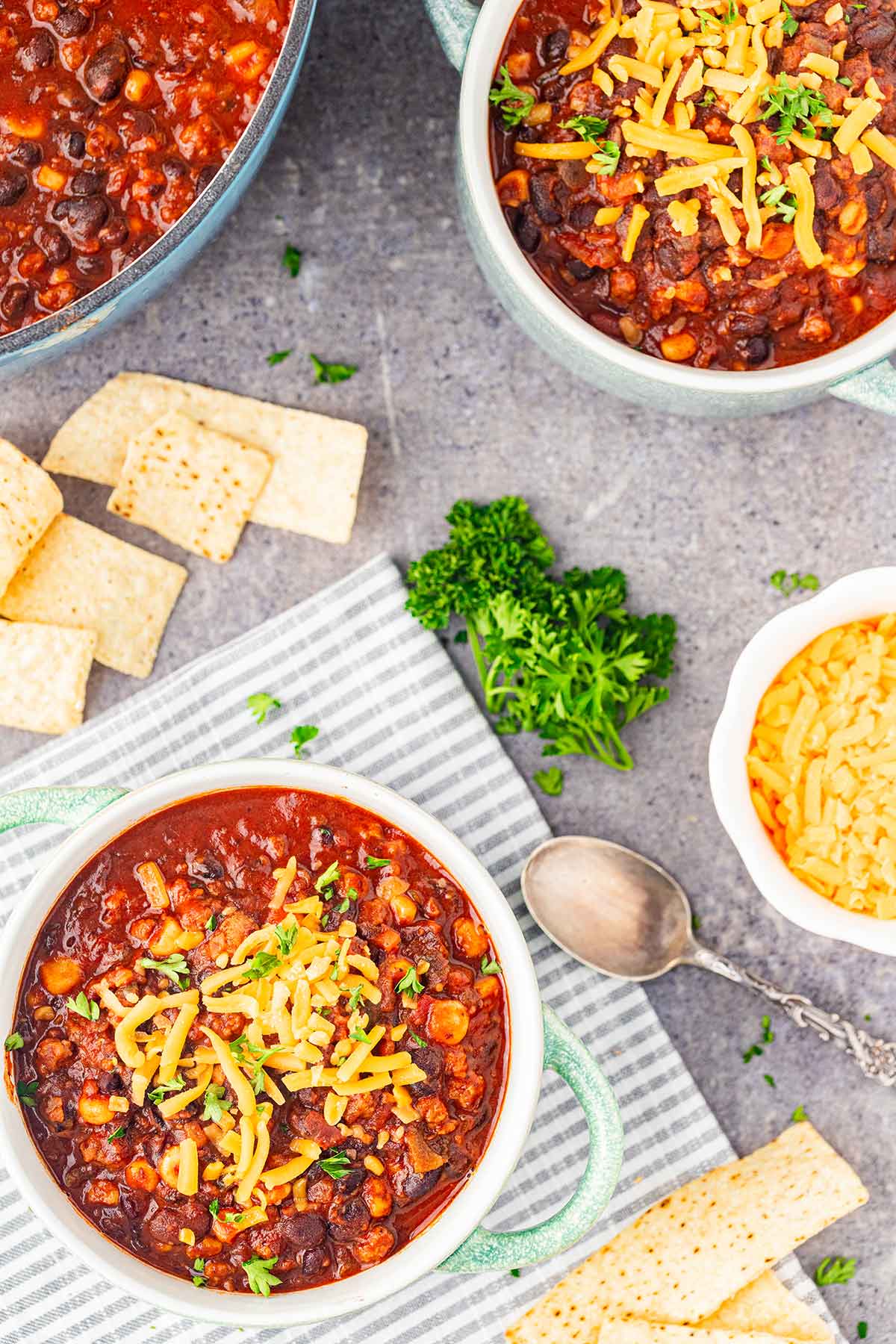 Overhead shot of table set with two bowls of Taco Soup in a Jar and garnishes.