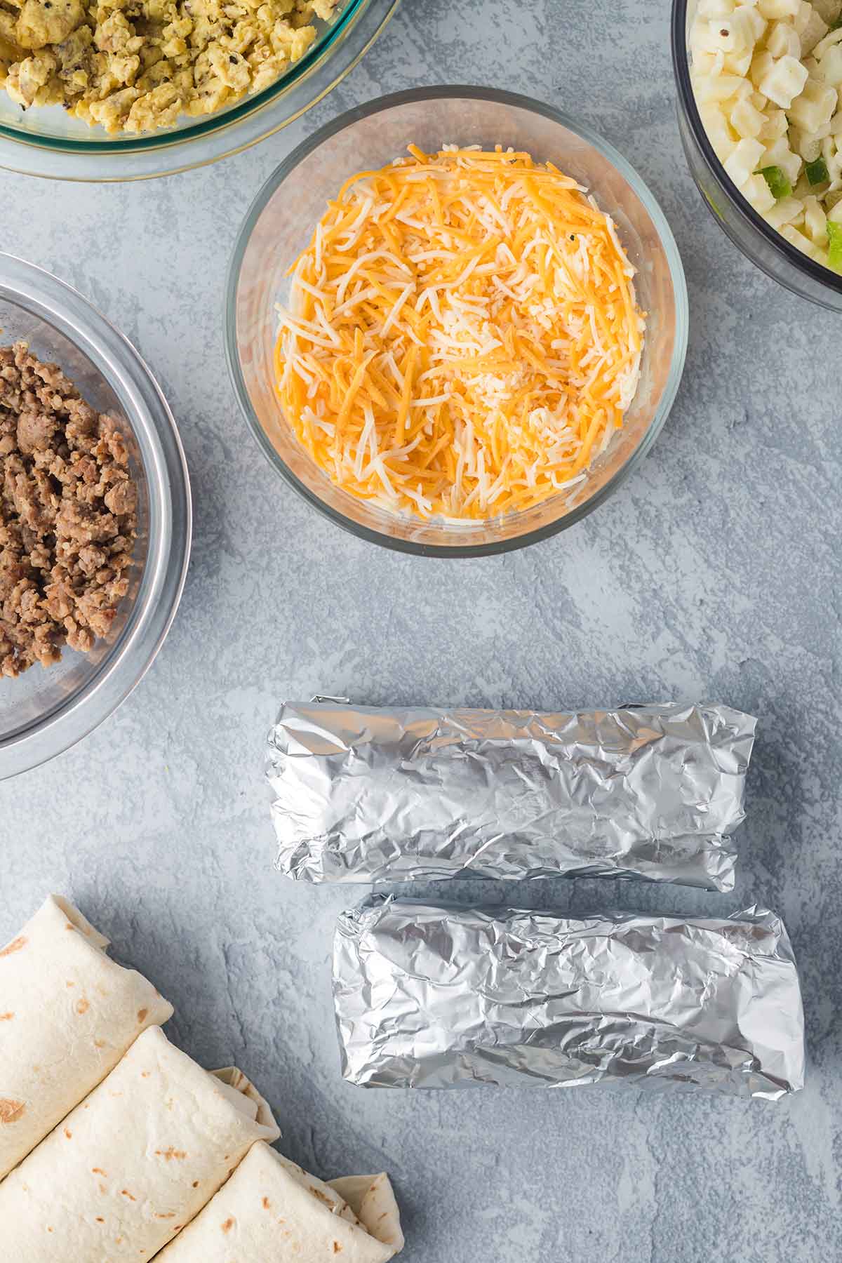 Overhead shot of breakfast burritos being prepped for freezing.