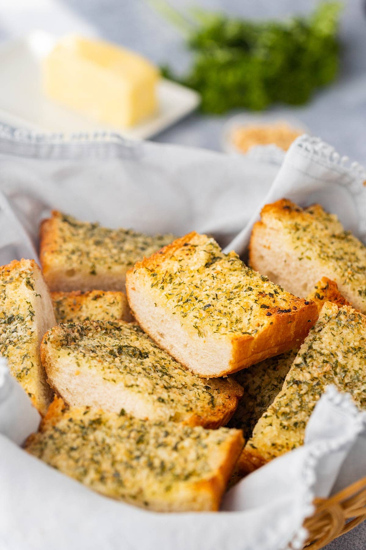 Pieces of make-ahead freezer garlic bread in a basket on a table.