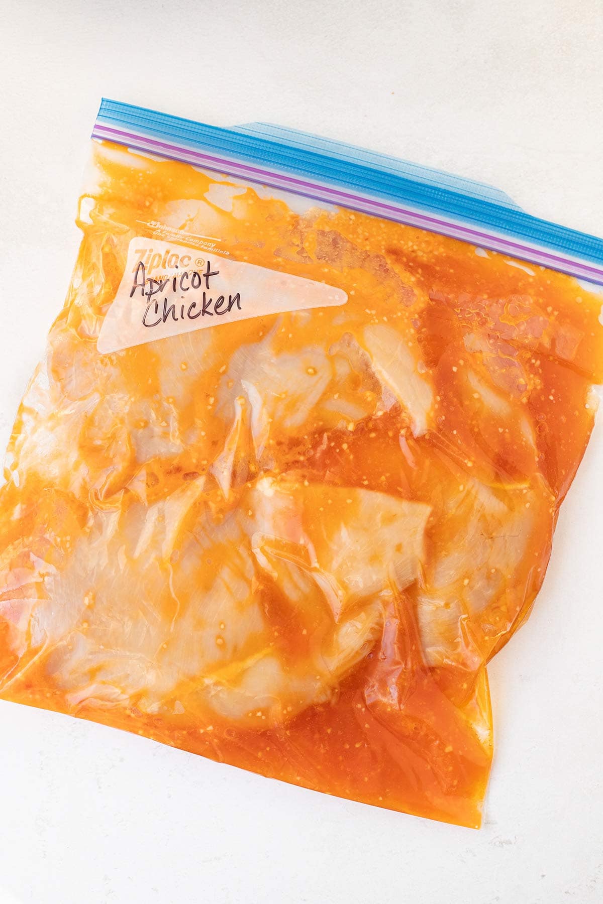 Overhead shot of freezer bag prepped with Crockpot Apricot Chicken freezer meal.