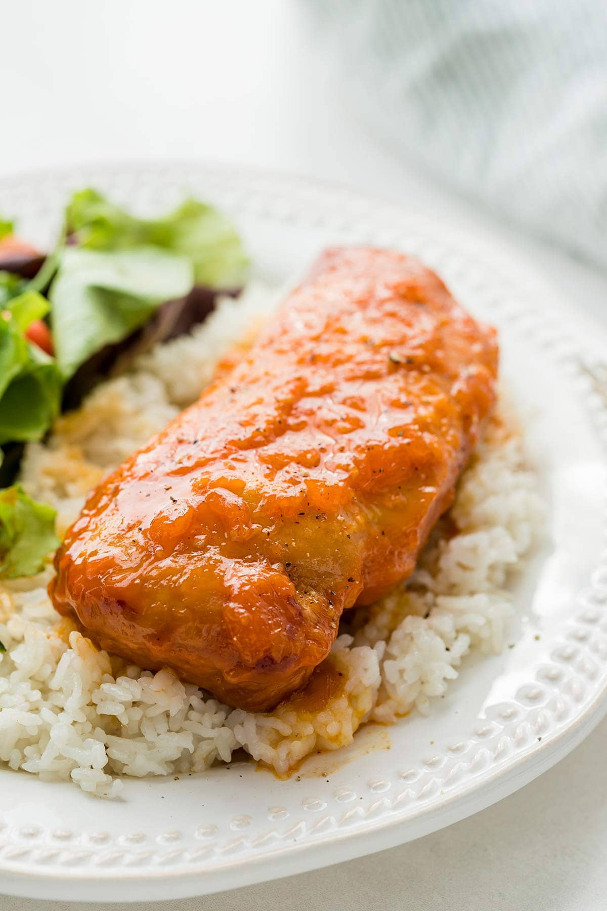 Slow Cooker Apricot Chicken on a bed of rice with a green salad.
