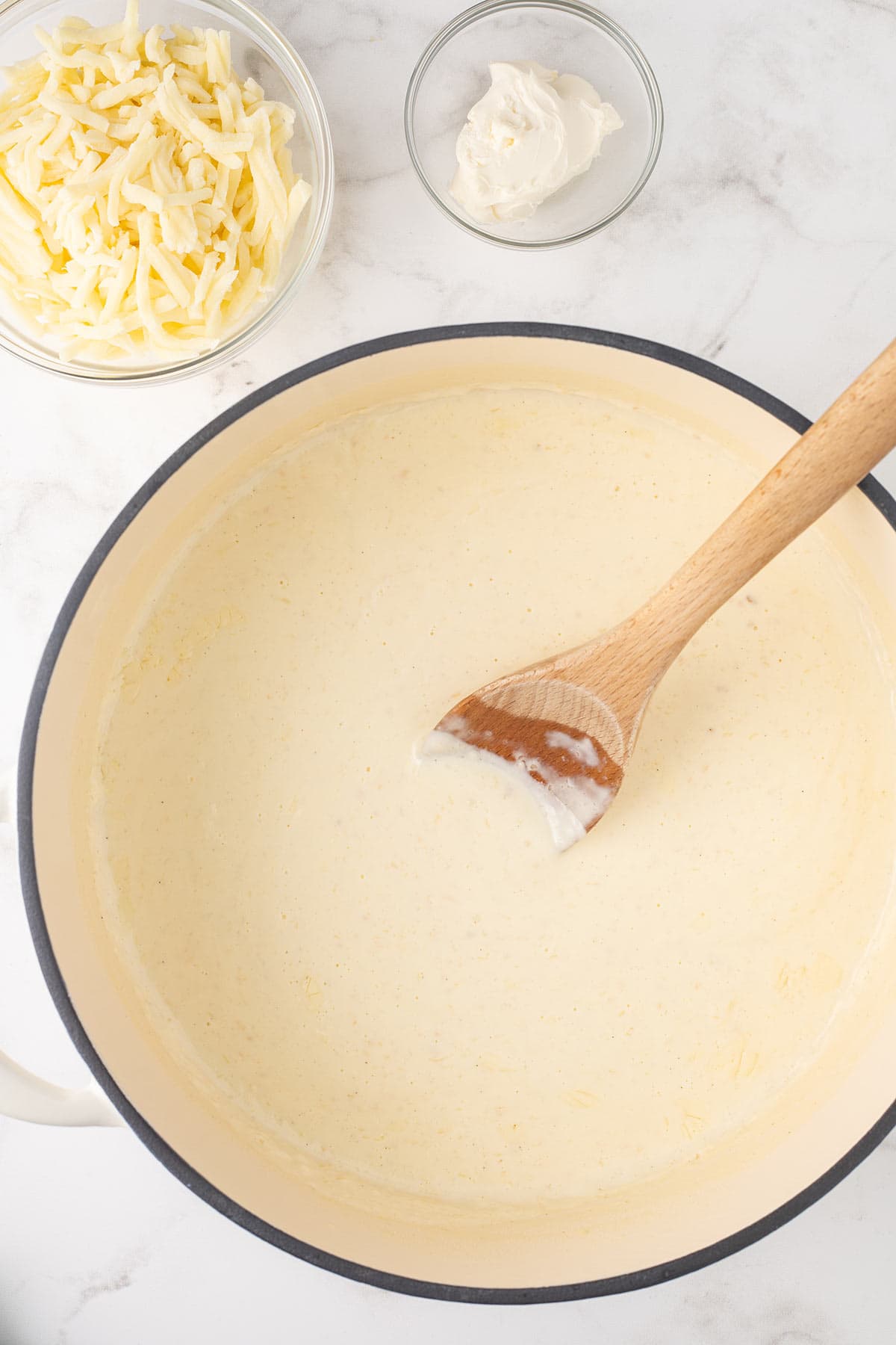 Making homemade alfredo sauce for Chicken Alfredo Bake.