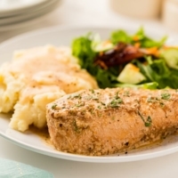 Slow Cooker French Onion Chicken plated with mashed potatoes and green salad.