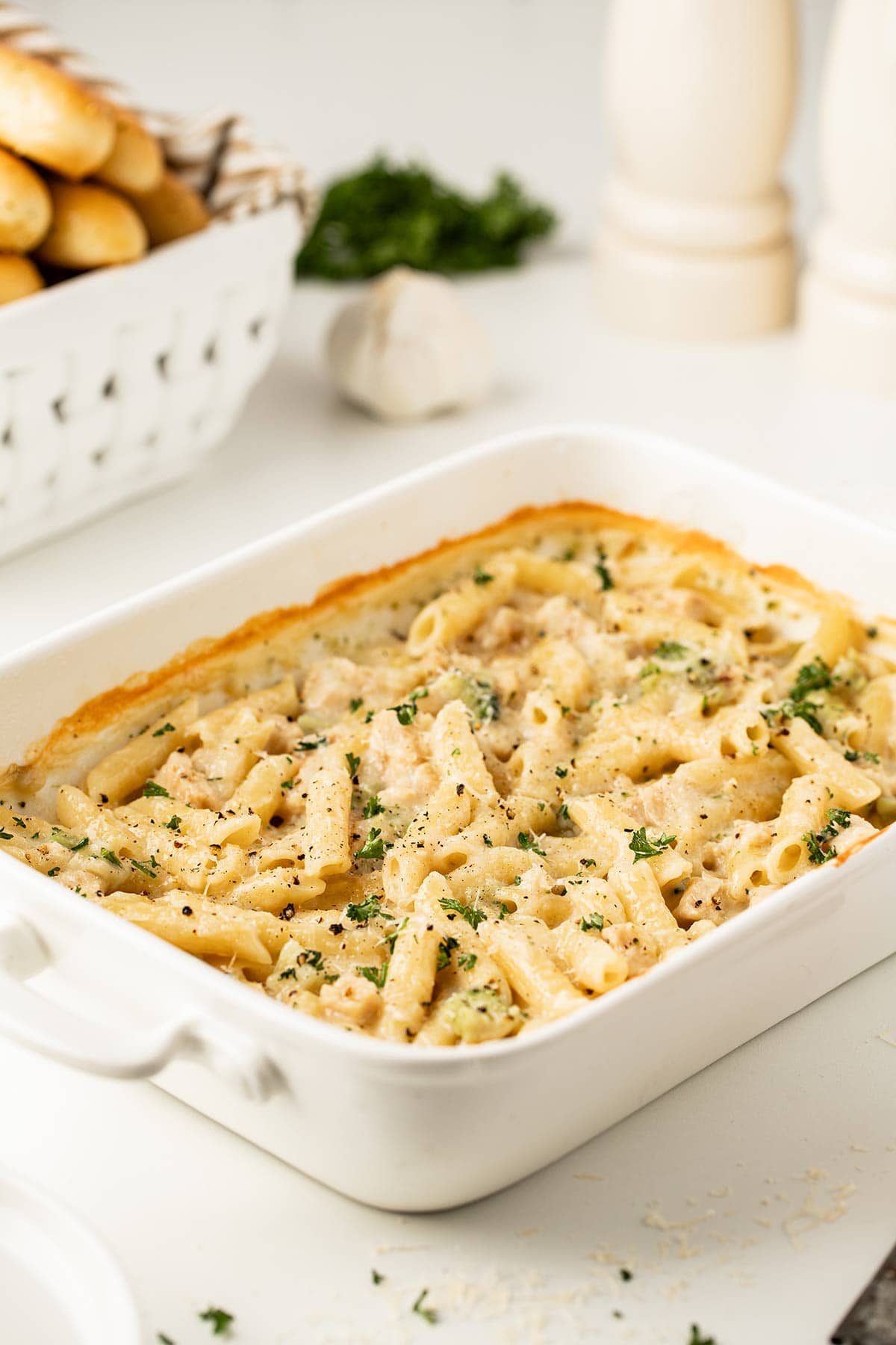 Baked Chicken Broccoli Alfredo Meal in a Jar in a white baking dish, garnished with fresh parsley.