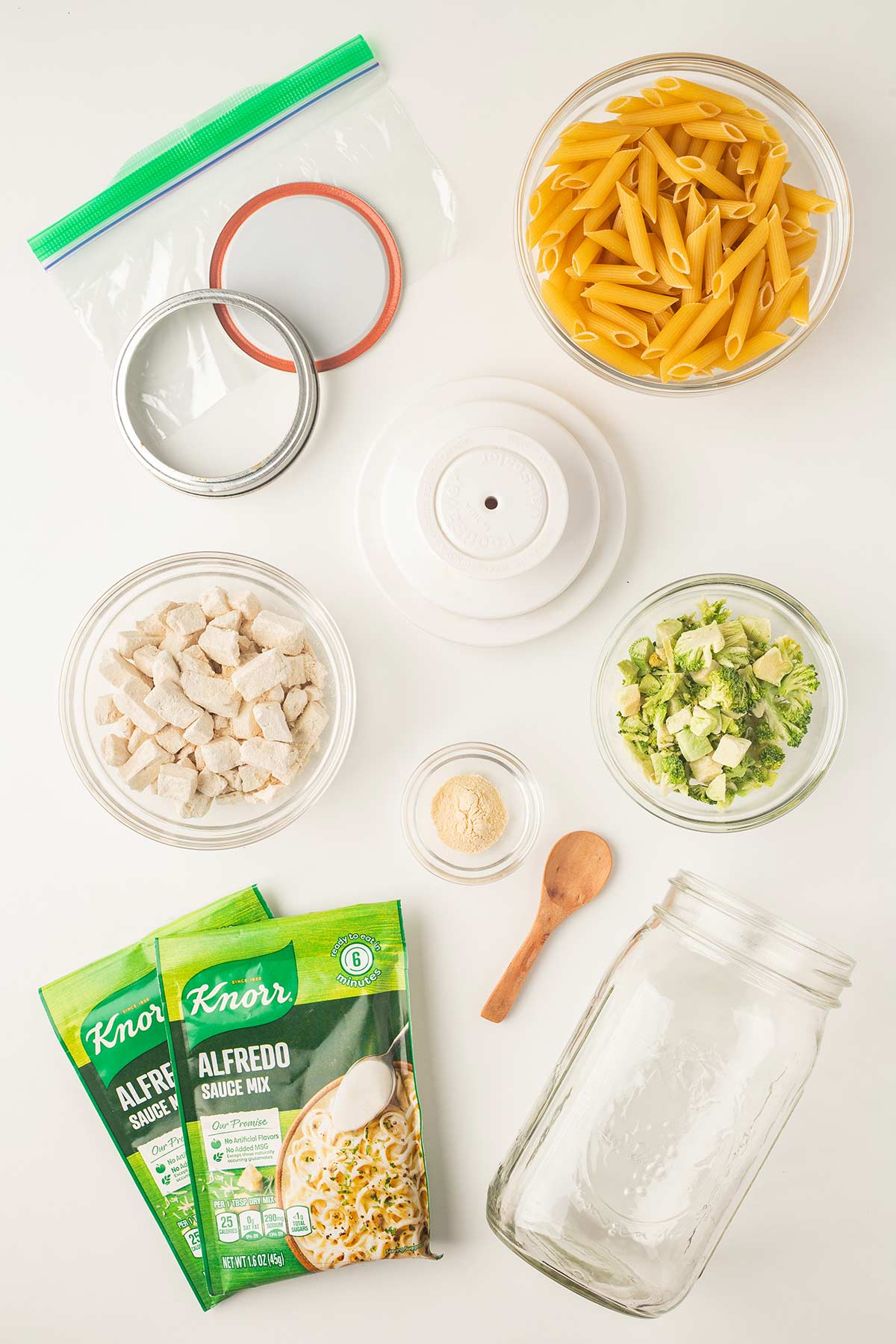 Overhead shot of ingredients needed to make the Chicken Broccoli Alfredo Meal in a Jar.