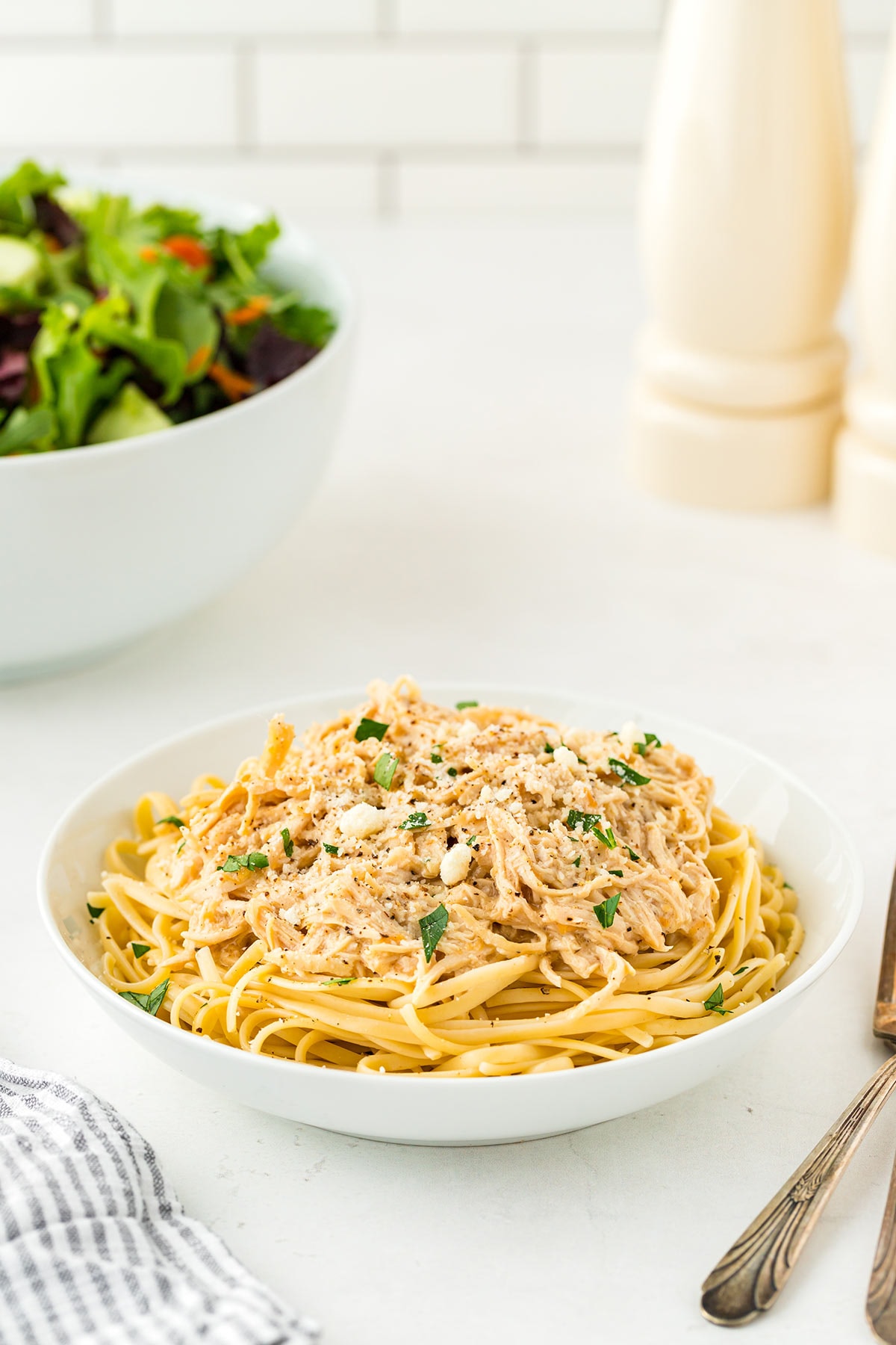 5-ingredient freezer meal recipe for Caesar Chicken, cooked and served over noodles.