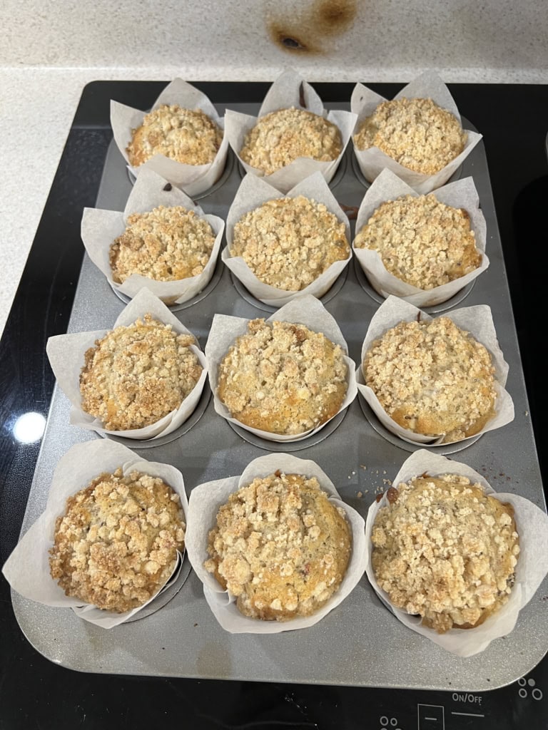 Tray of Cranberry White Chocolate Chip Muffins with White Chocolate Streusel, sitting on counter top.