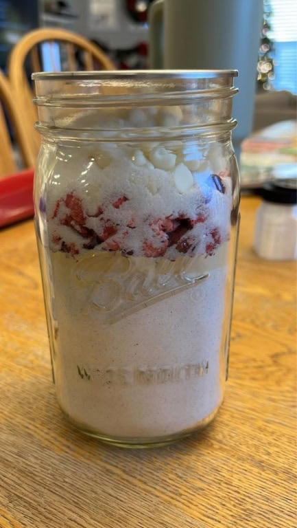 Jar of Cranberry White Chocolate Chip Muffin Mix in a Jar made up and sealed, ready to store or gift.