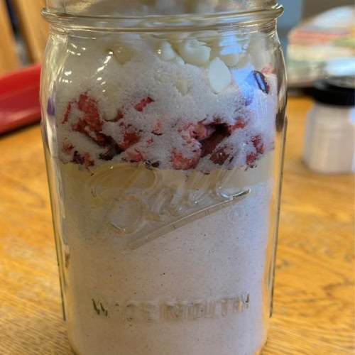 Jar of Cranberry White Chocolate Chip Muffin Mix in a Jar made up and sealed, ready to store or gift.